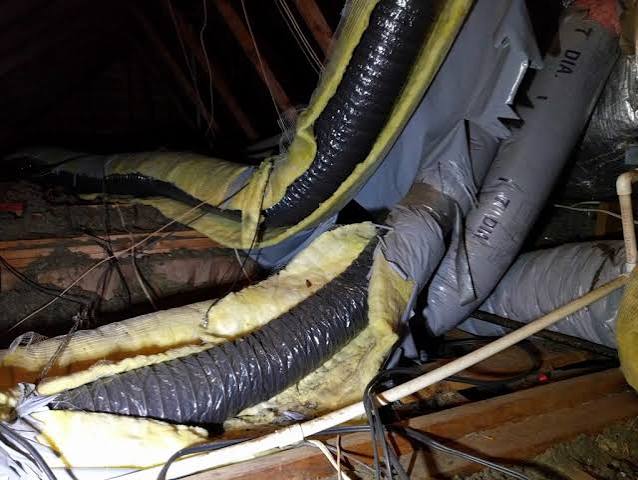 Deteriorating, sagging flexible ductwork in a damp Raleigh-area crawl space